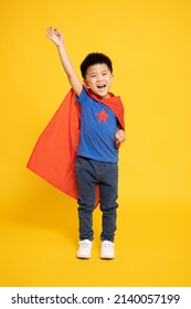 Smiling Superhero Asian Boy In Red Cape Isolated Yellow Background, Full Body Composition