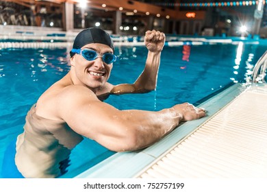 smiling swimmer gesturing and win in swimming pool - Powered by Shutterstock