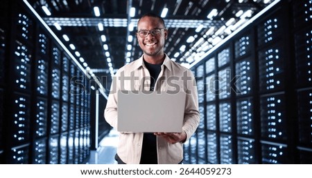Smiling IT Technician Setting Up Artificial Intelligence System In Server Room.
