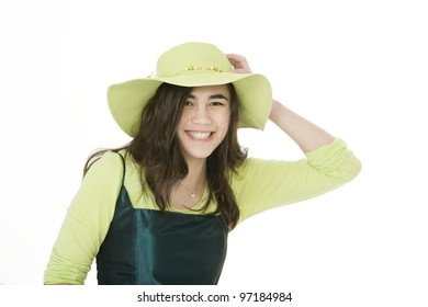 Smiling Teen  Biracial Girl In Green Dress And Lime Green Hat, Holding Onto Hat With One Hand