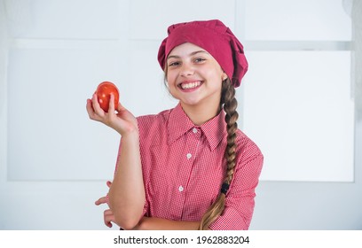 Smiling Teen Girl In Chef Uniform Cooking Vegetables, Tomato