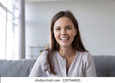 Smiling teen girl speaking by video call distance job interview looking at camera talking to webcam, female vlogger recording vlog at home, teacher student teach study online, head shot portrait