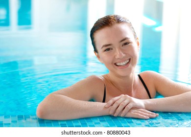 Smiling Teen Girl In A Swimming Pool With Copy Space