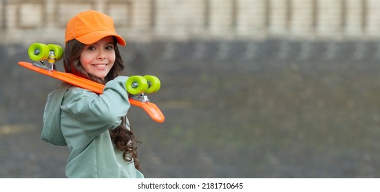 smiling teen kid skater with skateboard outdoor. girl with penny board. hipster girl with longboard - Powered by Shutterstock