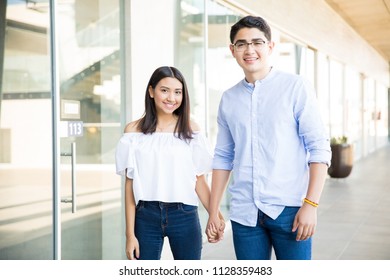 Smiling Teen Lovers Hanging Out Together In Shopping Mall