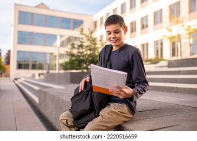 Smiling Teen Reading A Title On The Book Cover