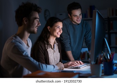 Smiling Teen Students Studying Late At Night And Using A Computer, Learning And Technology Concept