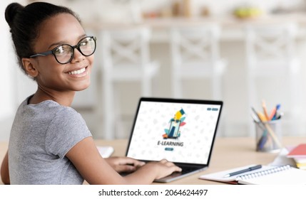 Smiling teenage african american cute girl pupil in glasses study online at home, double exposure with e-learning on laptop screen. Distance education, knowledge, virtual school due covid-19 pandemic