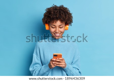 Similar – Image, Stock Photo A woman enjoying listening to music with her headphones