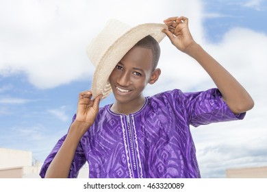 Smiling teenager holding a boater straw  hat