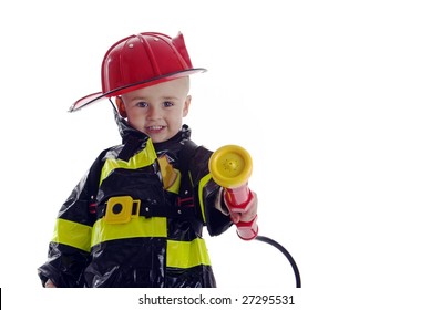 Smiling toddler fire fighter points water sprayer at camera