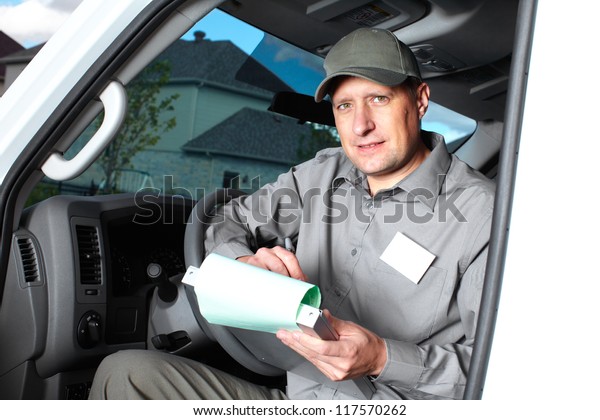 Smiling\
truck driver in the car. Delivery cargo\
service.
