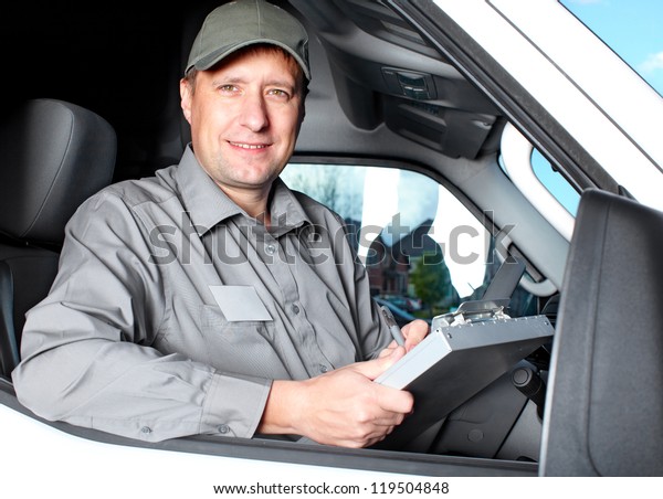 Smiling
truck driver in the car. Delivery cargo
service.