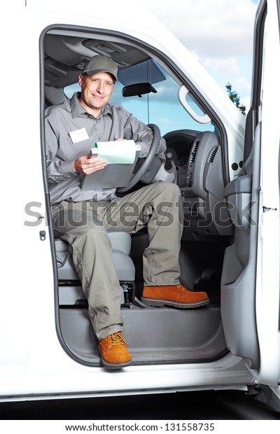 Smiling\
truck driver in the car. Delivery cargo\
service.