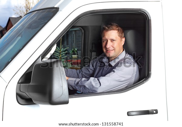 Smiling
truck driver in the car. Delivery cargo
service.
