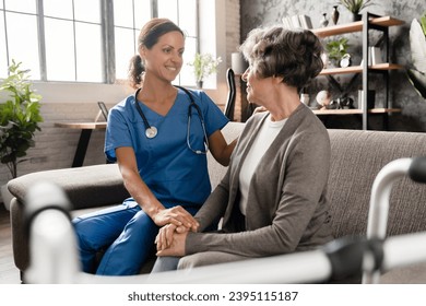 Smiling trustful caregiver nurse doctor medical worker taking care of elderly senior grandmother, hugging embracing on the sofa. Disabled handicapped old lady with sitter at hospice home - Shutterstock ID 2395115187