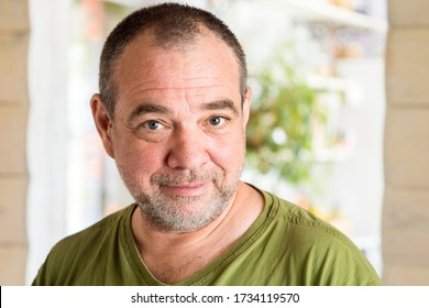 Smiling unshaven adult man at home