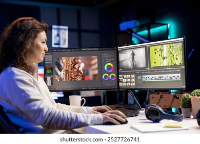 Smiling video editor using editing software to upgrade footage shot, commissioned by production teams outsourcing tasks. Happy freelancer videographer finishing project in apartment studio