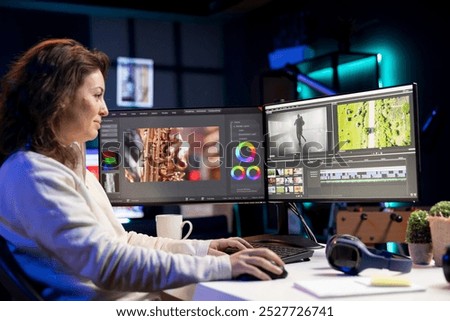 Smiling video editor using editing software to upgrade footage shot, commissioned by production teams outsourcing tasks. Happy freelancer videographer finishing project in apartment studio