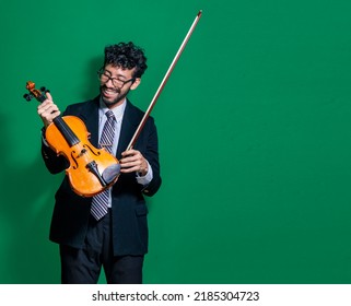 Smiling violinist man looking at camera and holding his violin, Violinist man concept on isolated background, Portrait of a smiling violinist man isolated