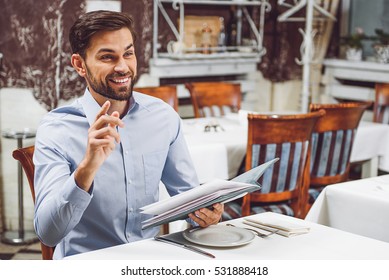 Smiling visitor waiting for waiter