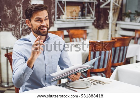 Smiling visitor waiting for waiter