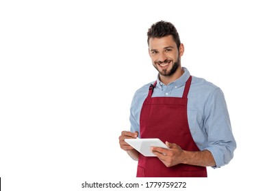 Smiling waiter looking at camera while using digital tablet isolated on white - Powered by Shutterstock