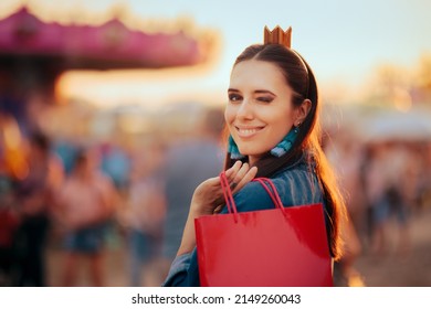Smiling Winking Woman Shopping in a Funfair Carnival. Happy cheerful shopper girl having fun in an amusement park
