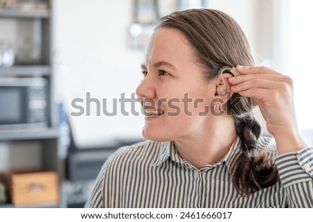 Similar – Image, Stock Photo Woman applying hearing aid to ear