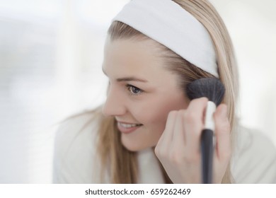 Smiling Woman Applying Makeup