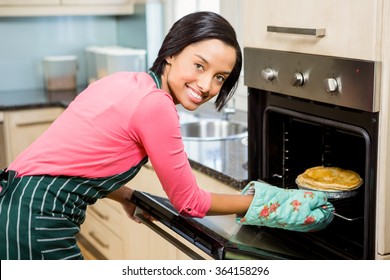 Smiling Woman Baking Pie At Home
