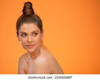 Smiling Woman With Bare Shoulders And Bun Hairstyle, Looking Back Over Shoulder, Isolated Portrait In Beauty Style, Girl Face Portrait With Natural No Retouching Skin.