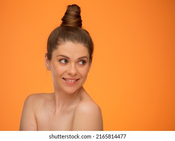 Smiling Woman With Bare Shoulders And Bun Hairstyle, Looking Back Over Shoulder, Isolated Portrait In Beauty Style, Girl Face Portrait With Natural No Retouching Skin.