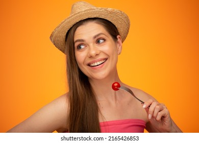 Smiling Woman With Bare Shoulders And Mexican Hat Eating Tomato And Looking Back Over Shoulder, Isolated Portrait In Beauty Style, Girl Face Portrait With Natural No Retouching Skin.