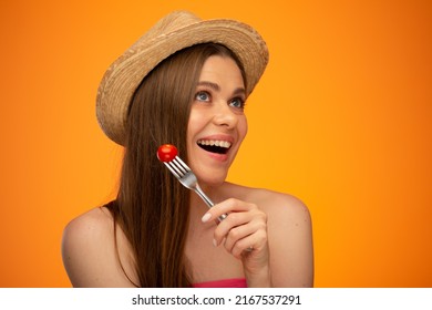 Smiling Woman With Bare Shoulders And Mexican Hat Looking Up And Eating Tomato, Isolated Portrait In Beauty Style, Girl Face Portrait With Natural No Retouching Skin.