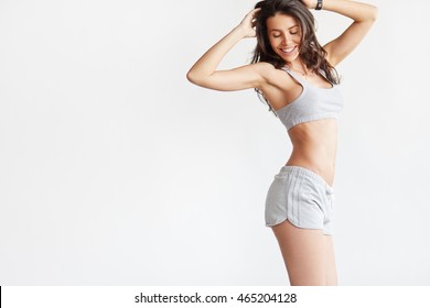 Smiling woman with beautiful body after diet, isolated on white with copyspace for text