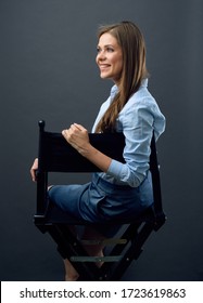 Smiling Woman Boss Sitting Back On Black Movies Director Chair Turns Away To Side. Isolated Female Profile Portrait.