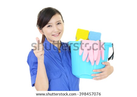 A smiling woman with a bucket