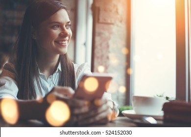 Smiling Woman In Cafe Using Mobile Phone And Texting In Social Networks, Sitting Alone