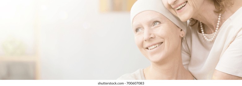 Smiling Woman With Cancer Hugged By Mother