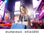 Smiling woman carrying some shopping bags on a city street