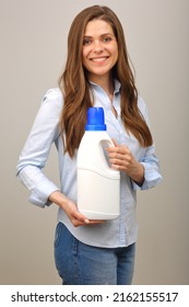 Smiling Woman In Casual Clothes Holding Laundry Detergent In White Bottle. Isolated Girl Portrait.