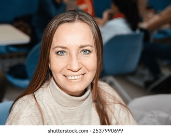 Smiling woman in casual setting with blue eyes and long hair - Powered by Shutterstock