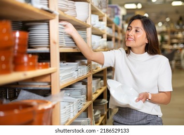 Smiling Woman Choosing New Crockery In Dinnerware Store