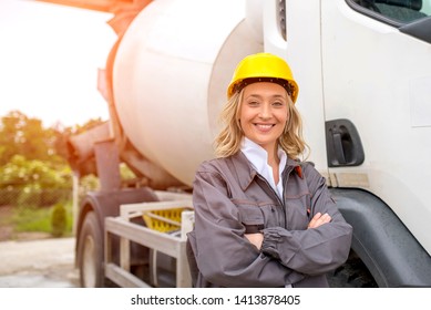 Smiling Woman, Concrete Truck Driver, With Safety Helmet Standing In Front Of  The Truck