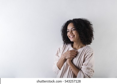 Smiling Woman With Dark Skin, Hands On Chest