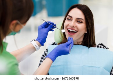 Smiling Woman At The Dentist's Appointment. Positive Girl Visits The Dentist And Wants To Make Her Teeth Even Better