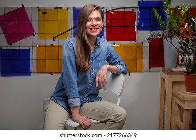 Smiling Woman Designer Student In Classroom With Color Palette Sitting On Chair.