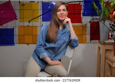 Smiling Woman Designer Student In Classroom With Color Palette Sitting On Chair.