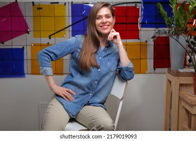 Smiling Woman Designer Student In Classroom With Color Palette Sitting On Chair.